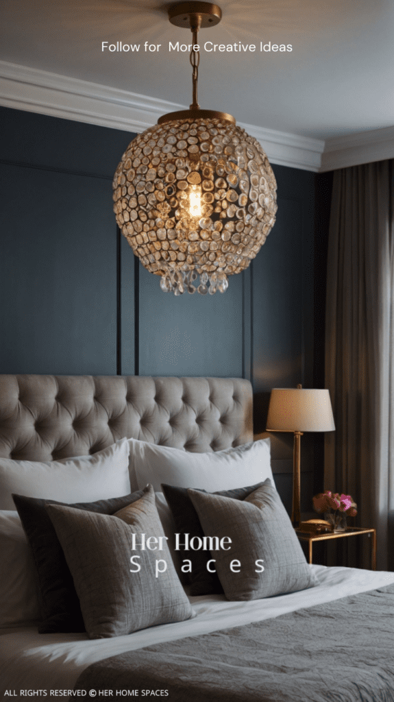 A bedroom featuring a statement pendant light, paired with bedside lamps and subtle ambient lighting.